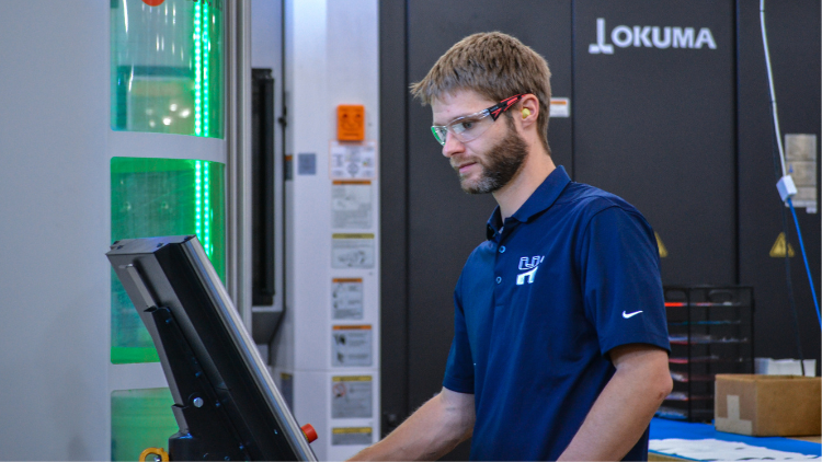 Machinist reads computer on shop floor