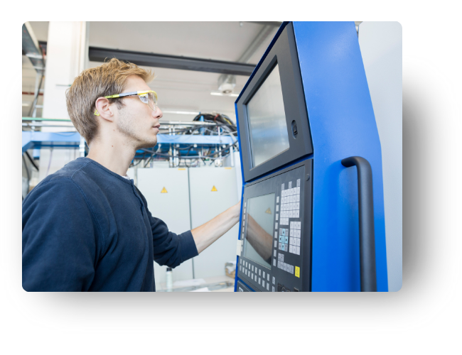 CNC programmer monitors G-code as mill runs